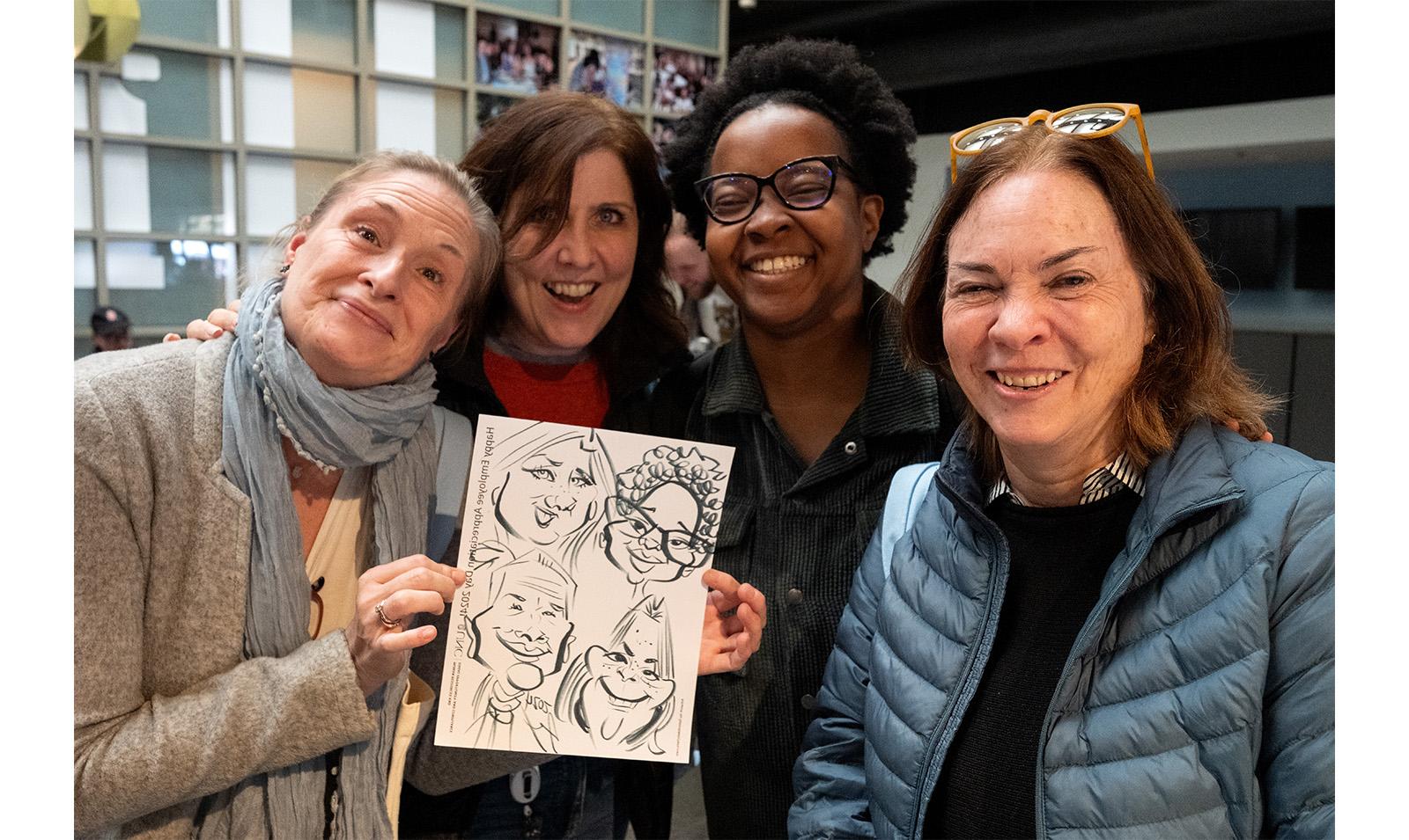 Carolina employees hold up custom caricature during Employee Appreciation Dau